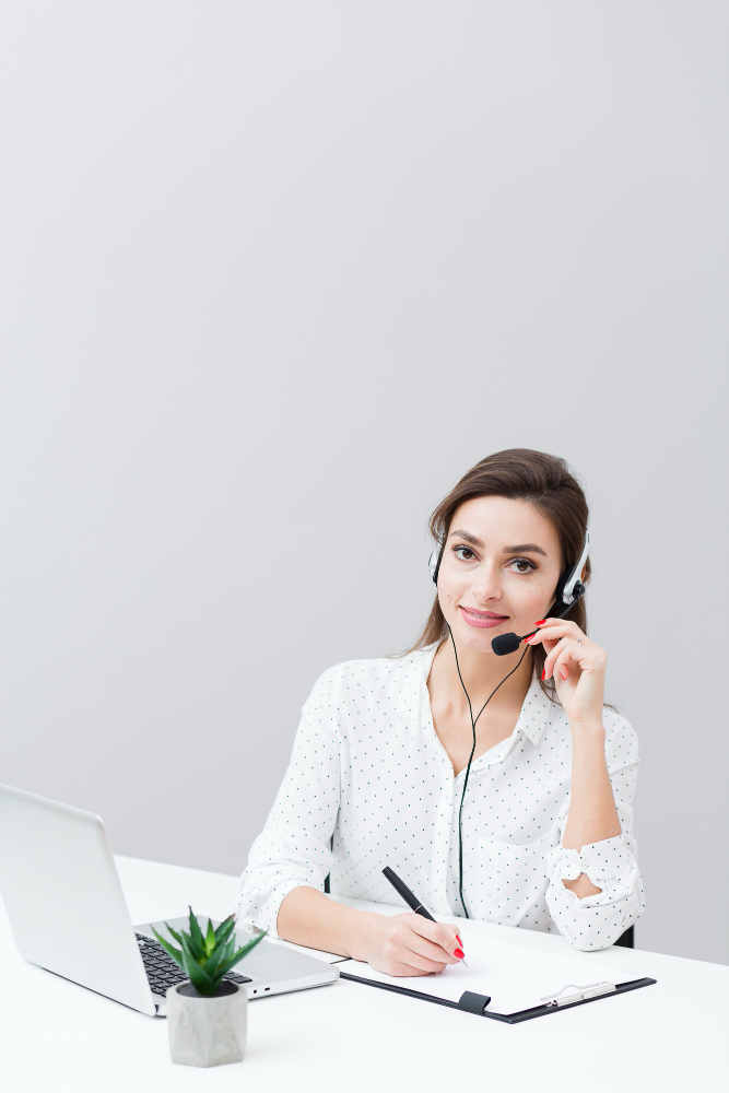 woman sitting beside table using laptop